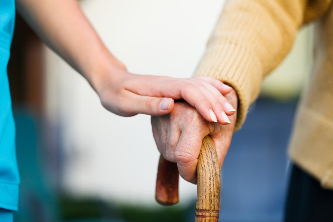 Caregiver holding the Hand of Care Recipient