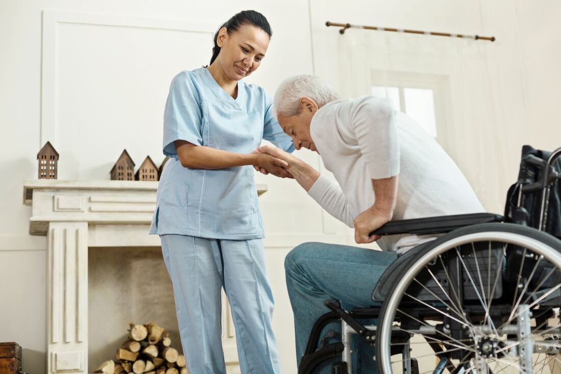 Caregiver Assisting an Elderly Man