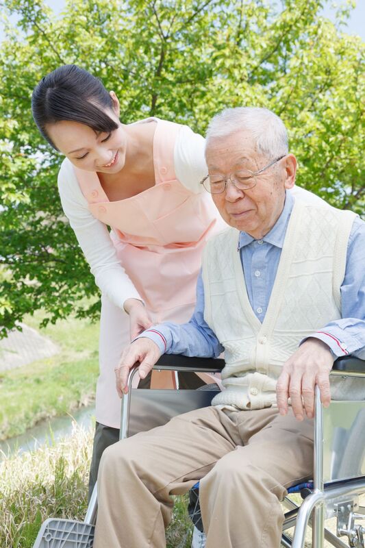 Caregiver giving elderly man a helping hand